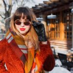 elegant-smiling-woman-retro-glasses-posing-outdoor_273443-3043